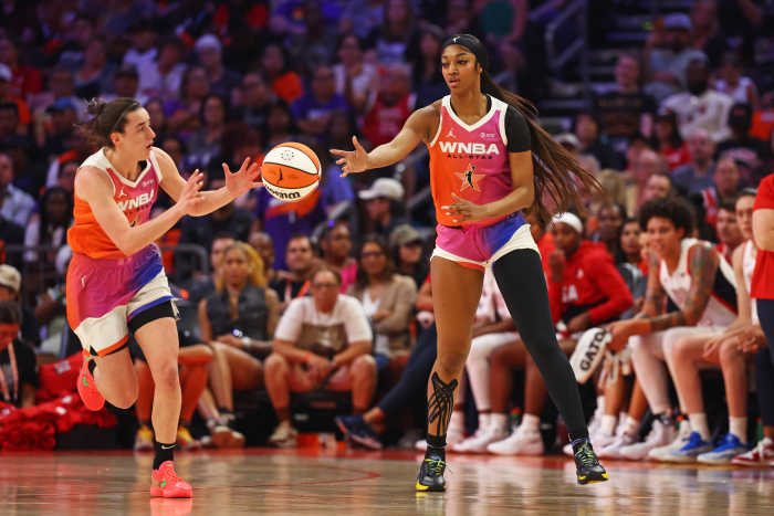 Team WNBA forward Angel Reese (5) passes the ball to Team WNBA guard Caitlin Clark (22)