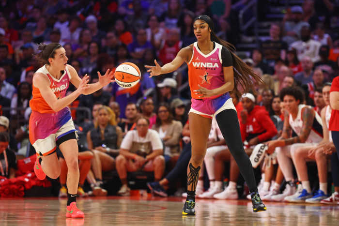 Team WNBA forward Angel Reese (5) passes the ball to Team WNBA guard Caitlin Clark (22) during the first half against the USA Women's National Team at Footprint Center.