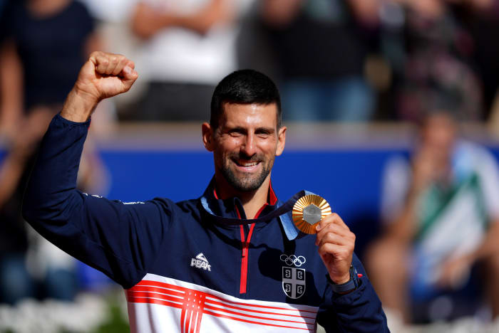 Novak Djokovic (SRB) celebrates after receiving his gold medal during the Paris 2024 Olympic Summer Games at Stade Roland Garros.