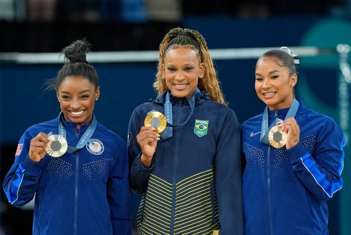 Simone Biles of the United States, Rebeca Andrade of Brazil, and Jordan Chiles of the United States with their medals on the floor exercise of the gymnastics event finals during the Paris 2024 Olympic Summer Games.