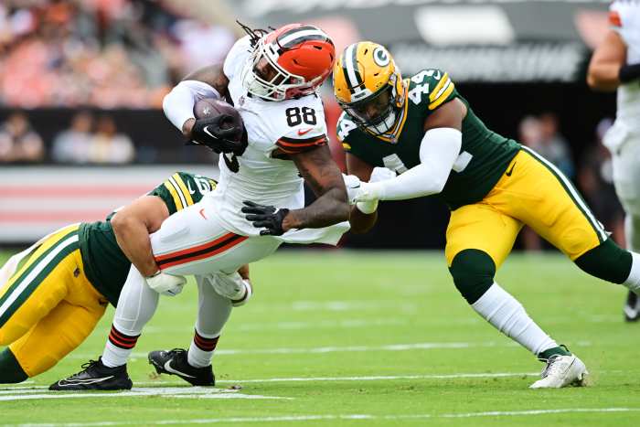 August 10, 2024; Cleveland, Ohio, USA; Green Bay Packers linebacker Ralen Goforth (44) and safety Evan Williams (33) tackle Cleveland Browns tight end Jordan Akins (88) during the first quarter at Cleveland Browns Stadium.