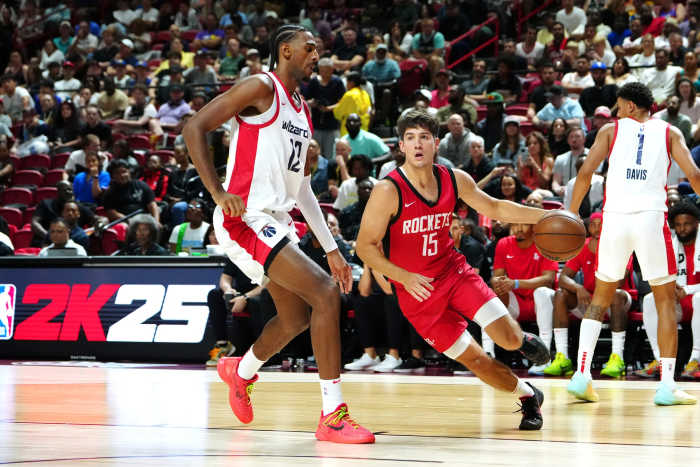 Las Vegas, NV, USA; Houston Rockets guard Reed Sheppard (15) dribbles around Washington Wizards forward Alex Sarr (12) during the third quarter at Thomas & Mack Center - Stephen R. Sylvanie-USA TODAY Sports
