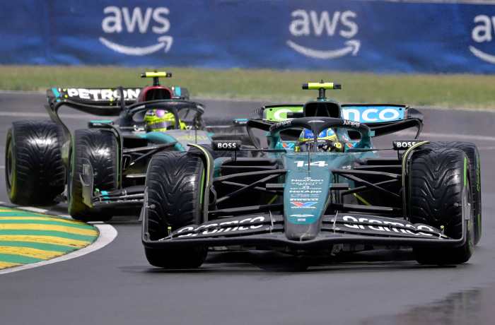 Jun 9, 2024; Montreal, Quebec, CAN; Aston Martin driver Fernando Alonso (ESP) and Mercedes driver Lewis Hamilton (GBR) race during the Canadian Grand Prix at Circuit Gilles Villeneuve.