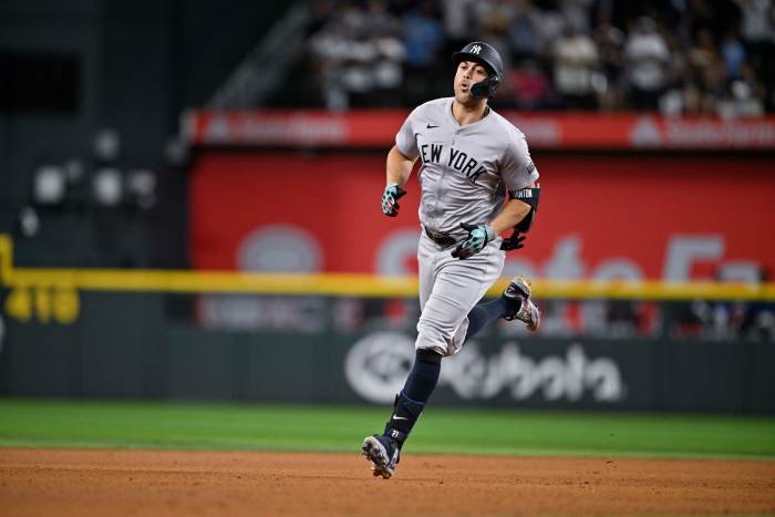 New York Yankees designated hitter Giancarlo Stanton rounds the bases after he hits a home run against the Texas Rangers.