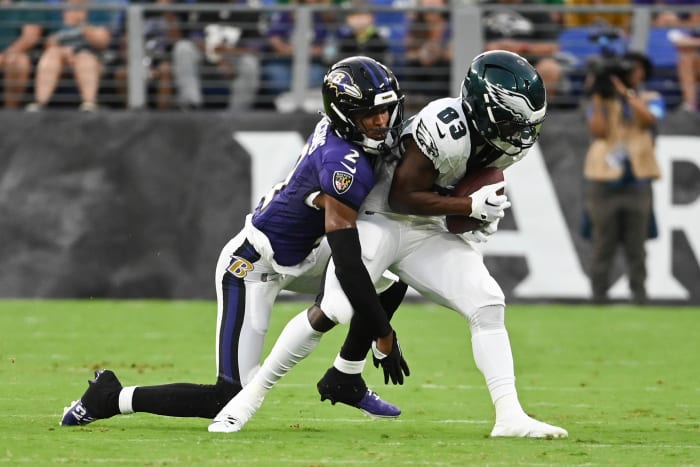 Philadelphia Eagles wide receiver John Ross (83) makes catch in front of Baltimore Ravens cornerback Nate Wiggins (2) during the first quarter of a preseason game at M&T Bank Stadium.