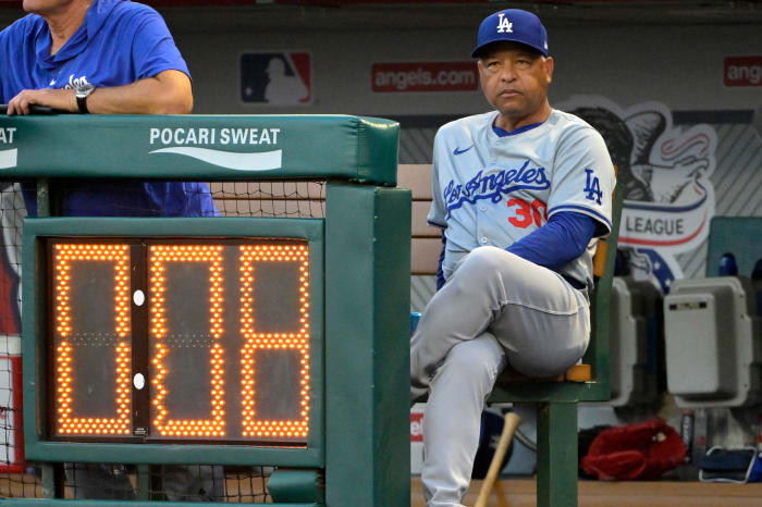 Sep 3, 2024; Anaheim, California, USA; Los Angeles Dodgers manager Dave Roberts (30) looks on from the dugout against the Los Angeles Angels at Angel Stadium.