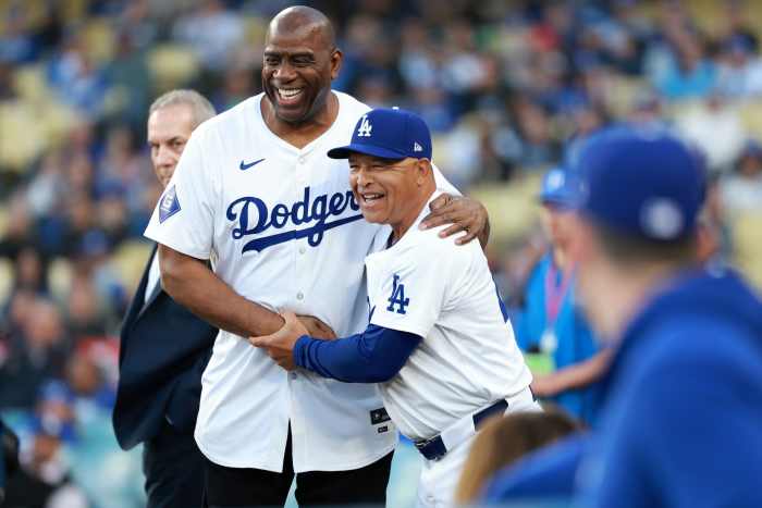 Magic Johnson (L) is greeted by Los Angeles Dodgers manager Dave Roberts (R) before the game against the Washington Nationals at Dodger Stadium - Kiyoshi Mio-Imagn Images