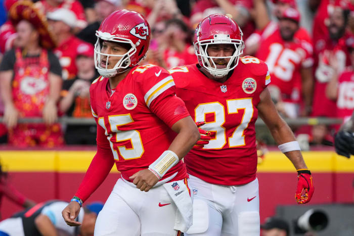 Patrick Mahomes (15) and tight end Travis Kelce (87) return to the sidelines. 