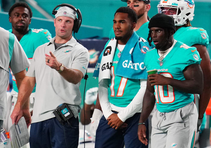 Miami Dolphins receivers coach Wes Welker, left, with wide receivers Jaylen Waddle (17) and Tyreek Hill during a preseason game against the Las Vegas Raiders at Hard Rock Stadium.