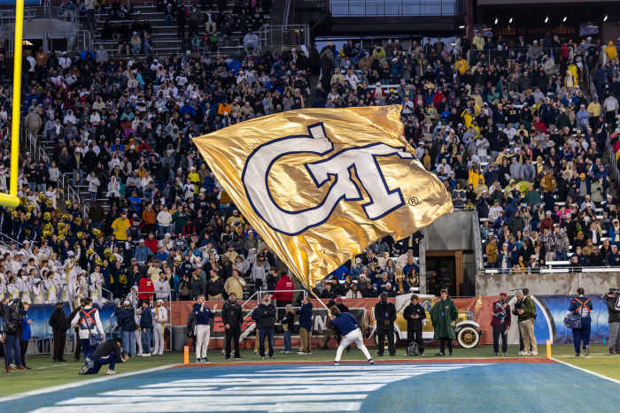 A Georgia Tech Yellow Jackets cheerleader waves the team flag during the second half of the 2024 Birmingham Bowl at Protective Stadium.