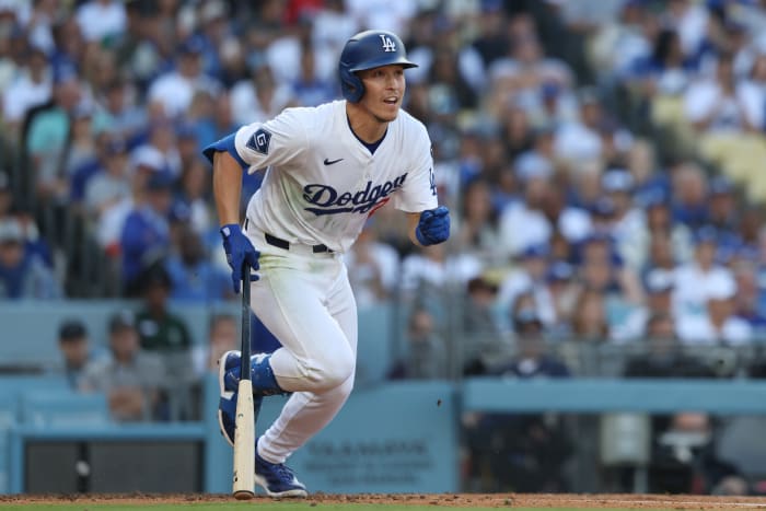 Los Angeles Dodgers outfielder Tommy Edman (25) hits an infield single against the Chicago Cubs during the fifth inning of the game at Dodger Stadium.