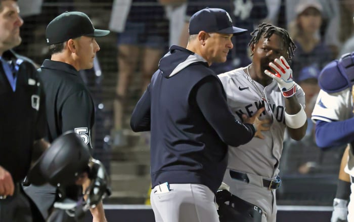 New York Yankees second base Jazz Chisholm Jr. (13) is ejected after he arguing as manager Aaron Boone (17) comes out during the seventh inning against the Tampa Bay Rays at George M. Steinbrenner Field.