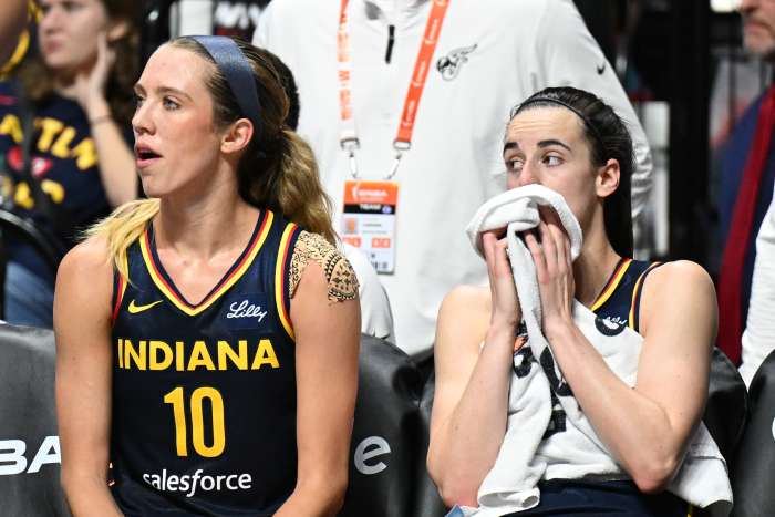 Indiana Fever guard Lexie Hull and Indiana Fever guard Caitlin Clark watch from the bench.