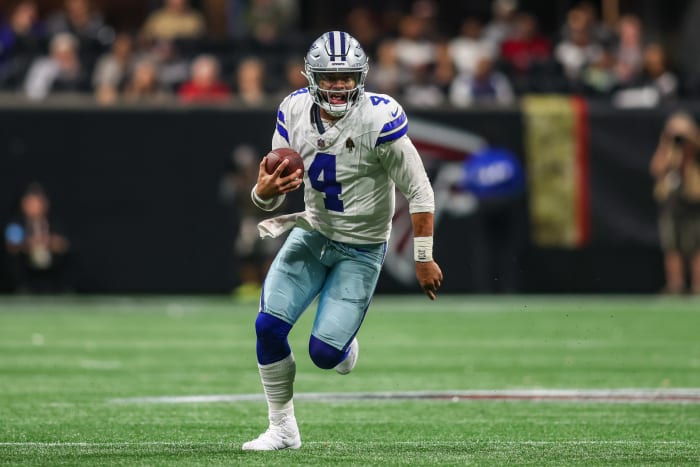 Dallas Cowboys quarterback Dak Prescott (4) scrambles against the Atlanta Falcons in the third quarter at Mercedes-Benz Stadium.