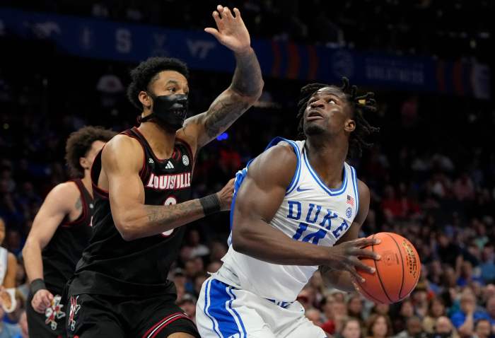 Duke Blue Devils guard Sion James (14) shoots against Louisville Cardinals forward James Scott (0).