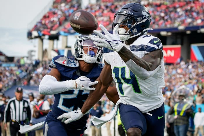 Ex-Seattle Seahawks wide receiver DK Metcalf (14) pulls in a touchdown past Tennessee Titans cornerback Tre Avery (23).