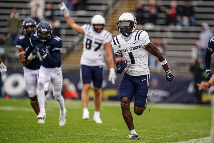 Sep 30, 2023; East Hartford, Connecticut, USA; Utah State Aggies wide receiver Jalen Royals (1) runs the ball for a touchdown against the UConn Huskies in the second half at Rentschler Field at Pratt & Whitney Stadium. Mandatory Credit: David Butler II-Imagn Images