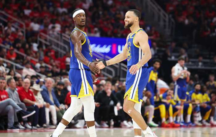 Golden State Warriors' Stephen Curry celebrates with Jimmy Butler III after a play against the Houston Rockets at Toyota Center.