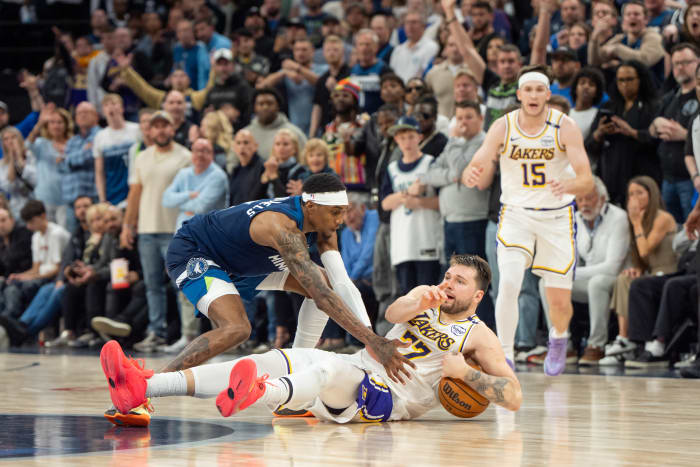 Los Angeles Lakers guard Luka Doncic (77) calls a timeout after stumbling on the defense of Minnesota Timberwolves forward Jaden McDaniels (3) in the fourth quarter during game four of first round for the 2025 NBA Playoffs at Target Center.