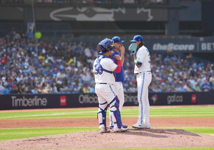 Toronto Blue Jays pitching coach Pete Walker (41) and starting pitcher Kevin Gausman (34)