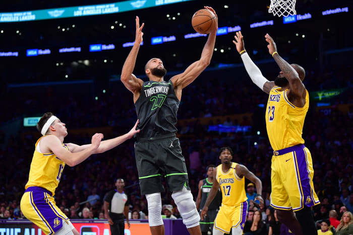 Timberwolves center Rudy Gobert (27) gets the rebound against Lakers guard Austin Reaves (15) and forward LeBron James (23).