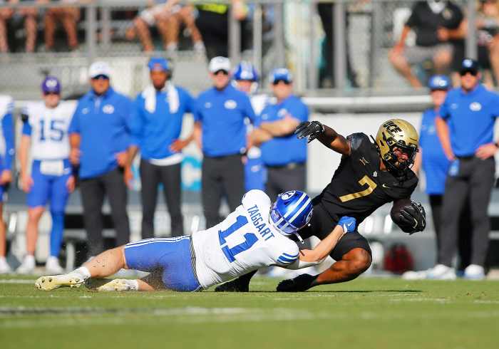 UCF Knights running back RJ Harvey (7) is tackled by BYU linebacker Harrison Taggart (11).