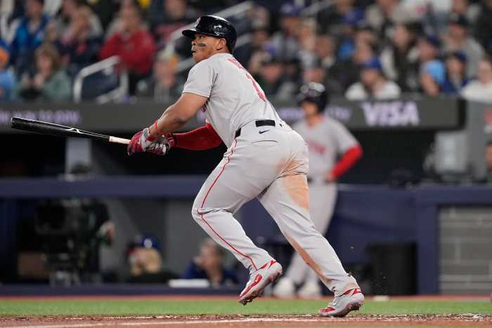 Boston Red Sox designated hitter Rafael Devers (11) hits a one-run double against the Toronto Blue Jays during the second inning at Rogers Centre.