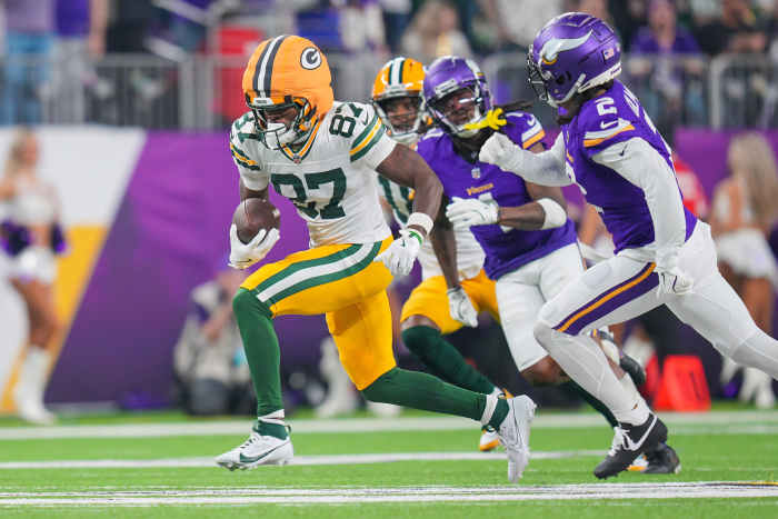 Packers WR Romeo Doubs (87) breaks a tackle and gains yards after the catch against the Minnesota Vikings in the fourth quarter at U.S. Bank Stadium.