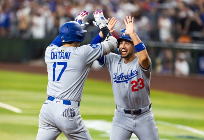 Los Angeles Dodgers designated hitter Shohei Ohtani celebrates with teammate Michael Conforto after hitting a three-run home run in the ninth inning against the Arizona Diamondbacks at Chase Field.