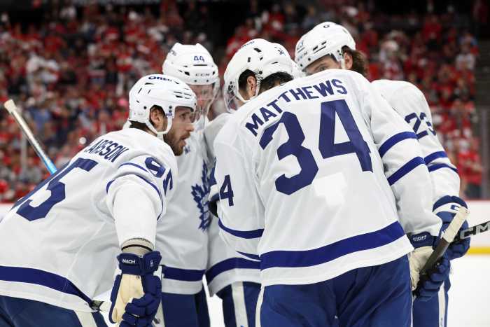 Maple Leafs center Auston Matthews (34) talks with Oliver Ekman-Larsson (95), Morgan Rielly (44), Matthew Knies (23) and Mitch Marner (16) against the Panthers.