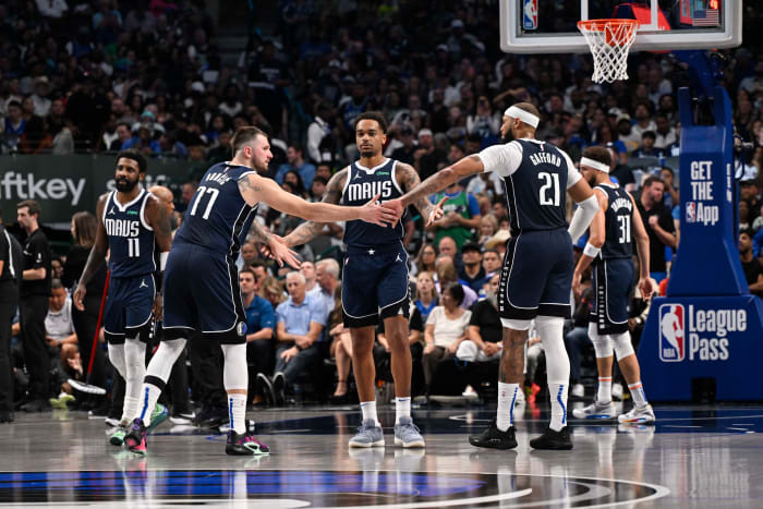 Dallas Mavericks guard Kyrie Irving (11) and guard Luka Doncic (77) and forward P.J. Washington (25) and center Daniel Gafford (21) and guard Klay Thompson (31)