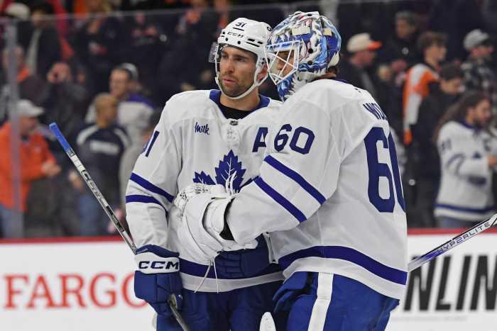 Toronto Maple Leafs center John Tavares (91) and goaltender Joseph Woll (60) celebrate a win.