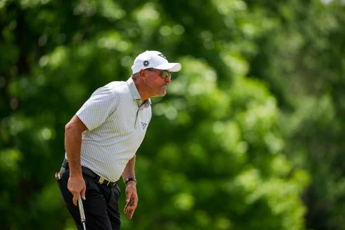 Phil Mickelson lines up his putt on the ninth hole during the first round of the PGA Championship golf tournament at Quail Hollow.
