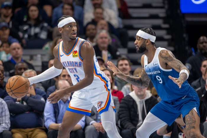 Oklahoma City Thunder guard Shai Gilgeous-Alexander (2) defended by Minnesota Timberwolves guard Nickeil Alexander-Walker (9)