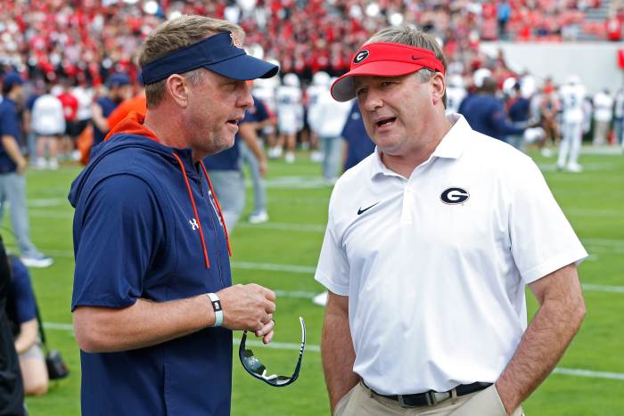 Auburn head coach Hugh Freeze speaks with Georgia head coach Kirby Smart