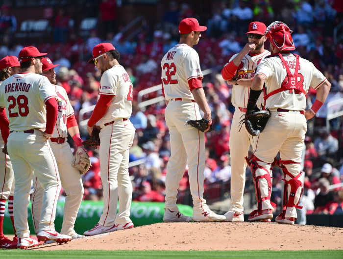 Apr 12, 2025; St. Louis, Missouri, USA; St. Louis Cardinals pitching coach Dusty Blake (90, second from right) talks over the situation with St. Louis Cardinals pitcher Steven Matz (32, left) and St. Louis Cardinals catcher Pedro Pages (43, right) in the sixth inning in a game against the Philadelphia Phillies at Busch Stadium, as the Cardiinals infield chats at left.