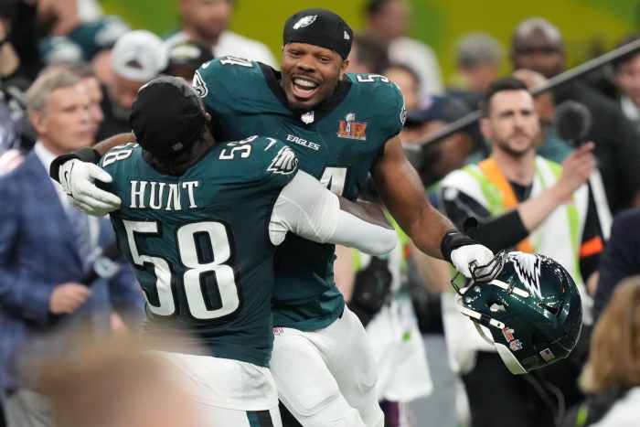 Philadelphia Eagles linebacker Jeremiah Trotter Jr. (54) reacts with linebacker Jalyx Hunt (58) after defeating the Kansas City Chiefs in Super Bowl LIX at Caesars Superdome