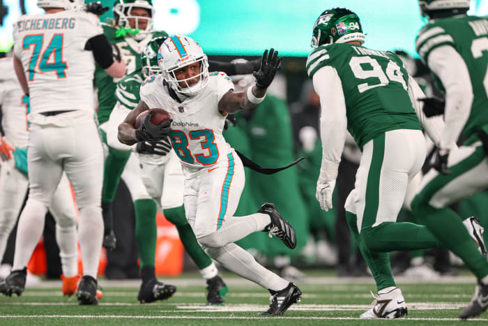 Jan 5, 2025; East Rutherford, New Jersey, USA; Miami Dolphins wide receiver Malik Washington (83) gains yards after catch asNew York Jets defensive end Solomon Thomas (94) pursues during the second half at MetLife Stadium.