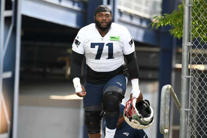 New England Patriots guard Mike Onwenu (71) walks to the practice field at the Patriots training camp at Gillette Stadium.