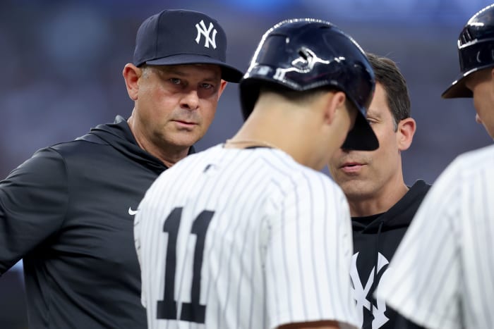 New York Yankees manager Aaron Boone (17) and shortstop Anthony Volpe (11)