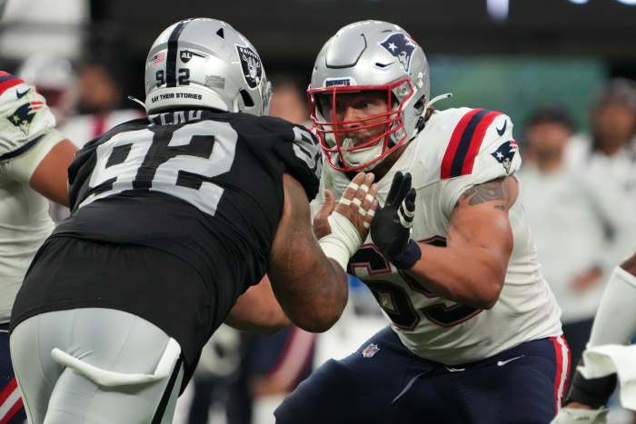 New England Patriots guard Cole Strange (69) defends against Las Vegas Raiders defensive tackle Kyle Peko (92) at Allegiant Stadium.