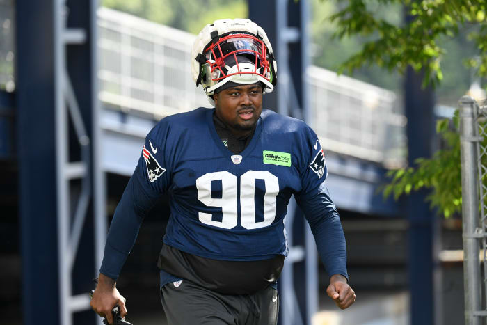 New England Patriots defensive end Christian Barmore (90) walks to the practice field at the Patriots training camp at Gillette Stadium. 