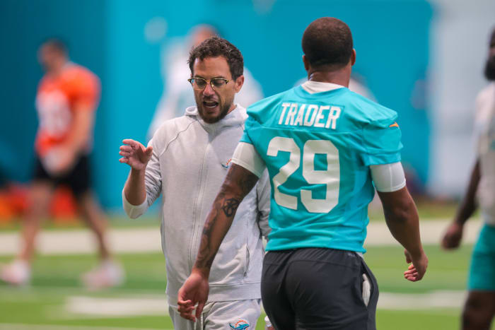 Miami Dolphins head coach Mike McDaniel talks to safety Dante Trader Jr. (29) during mandatory minicamp at Hard Rock Stadium.
