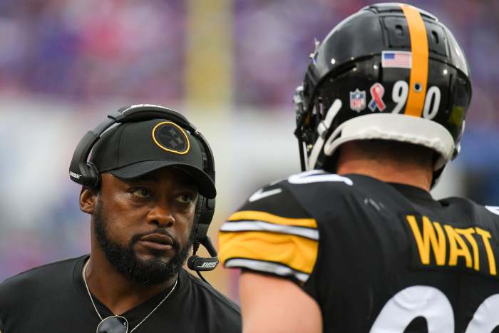 Pittsburgh Steelers head coach Mike Tomlin talks with outside linebacker T.J. Watt (90) against the Buffalo Bills during the second half at Highmark Stadium.