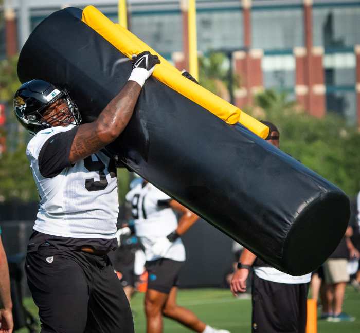 Jacksonville Jaguars defensive tackle Maason Smith wraps up a tackling dummy at team drills.
