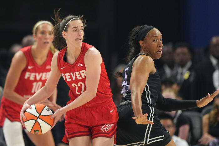 Indiana Fever guard Caitlin Clark (22) handles the ball against Golden State Valkyries forward Kayla Thornton (5).
