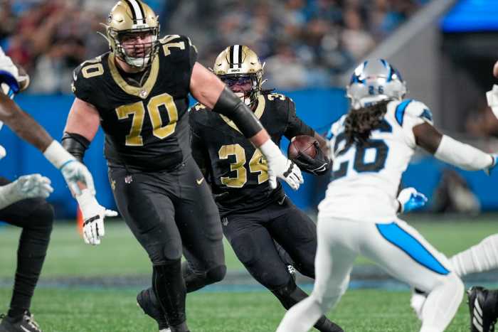 Sep 18, 2023; New Orleans Saints running back Tony Jones Jr. (34) follows a block by offensive tackle Trevor Penning (70) against the Carolina Panthers. Mandatory Credit: Jim Dedmon-Imagn Images