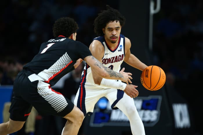 Mar 20, 2025; Wichita, KS, USA; Gonzaga Bulldogs guard Ryan Nembhard (0) dribbles against Georgia Bulldogs guard Dakota Leffew (1) in the first half of a first round men’s NCAA Tournament game at Intrust Bank Arena. Mandatory Credit: Nick Tre. Smith-Imagn Images