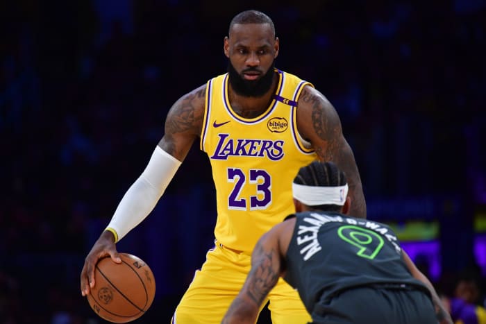 Los Angeles Lakers forward LeBron James controls the ball as Minnesota Timberwolves guard Nickeil Alexander-Walker defends during their playoff game at Crypto.com Arena on April 30, 2025.