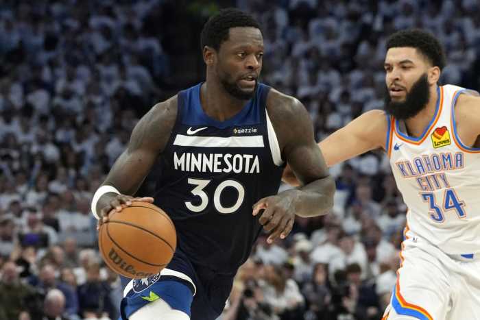 Minnesota Timberwolves forward Julius Randle drives with the ball as Oklahoma City Thunder forward Kenrich Williams defends during their playoff game at Target Center on May 24, 2025.
